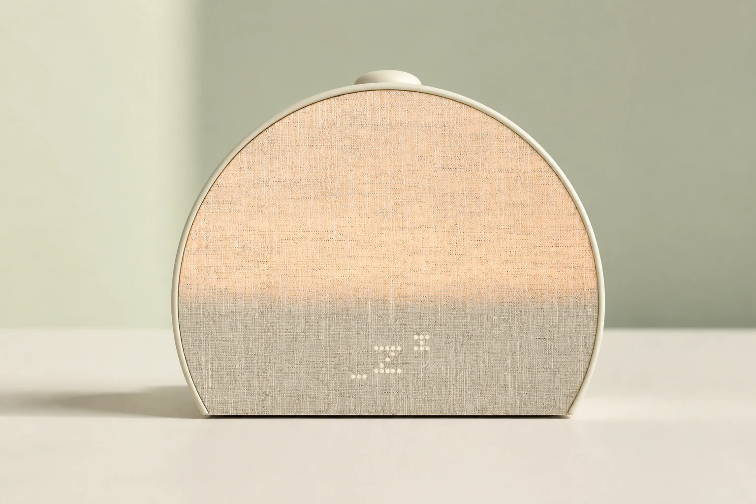 Hatch Sleep Clock model details Front view of the Putty Hatch Sleep Clock with its warm fabric light and sleep symbol
