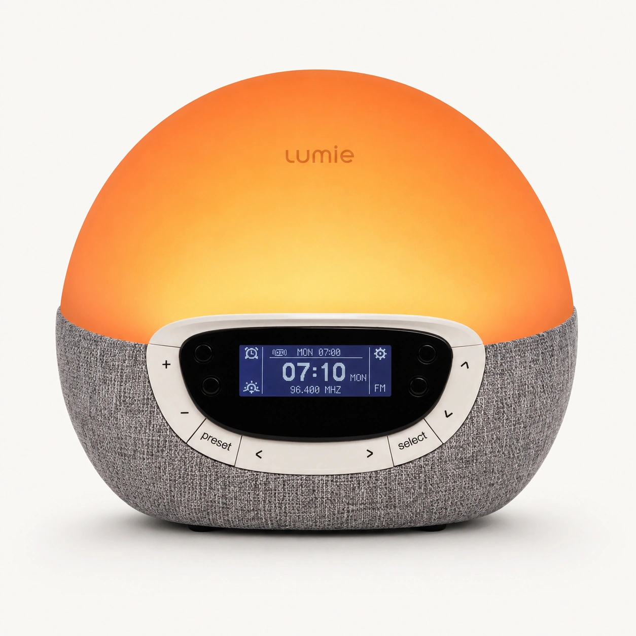 Lumie Bodyclock Rise300 alarm clock with sunrise simulation glowing warmly on a bedside surface Lumie Bodyclock Rise300 alarm clock with sunrise simulation glowing warmly on a bedside surface